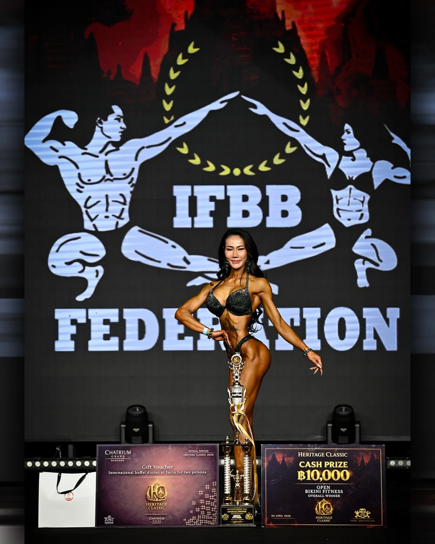 J. Buranapawung on the IFBB Heritage Classic stage with the bikini fitness overall winner trophy