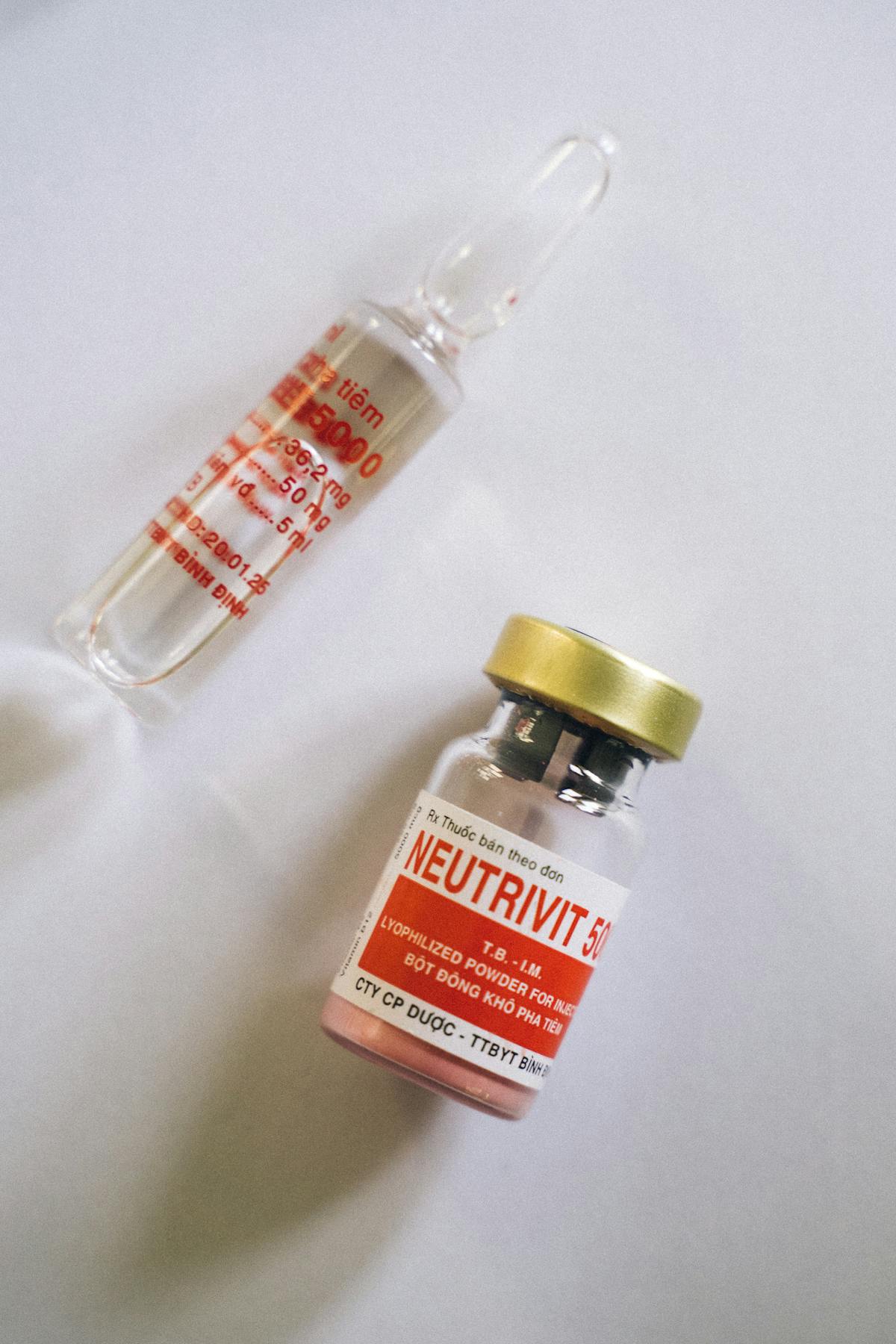 Unlabeled vials being filled with amber liquid — no batch number, no documentation